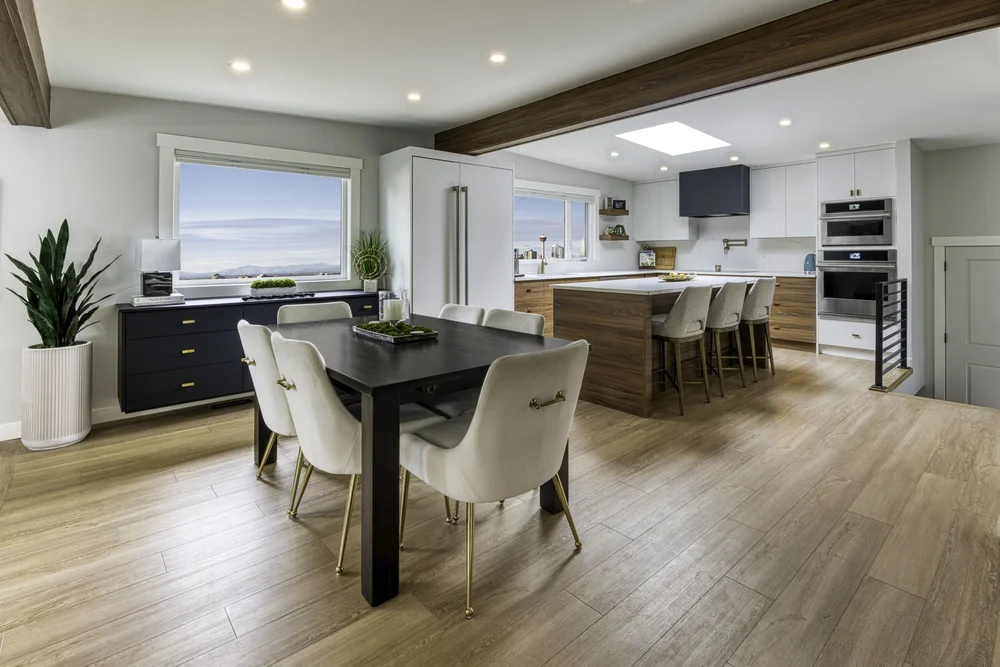 Open-plan kitchen and dining area with a light wood-look floor